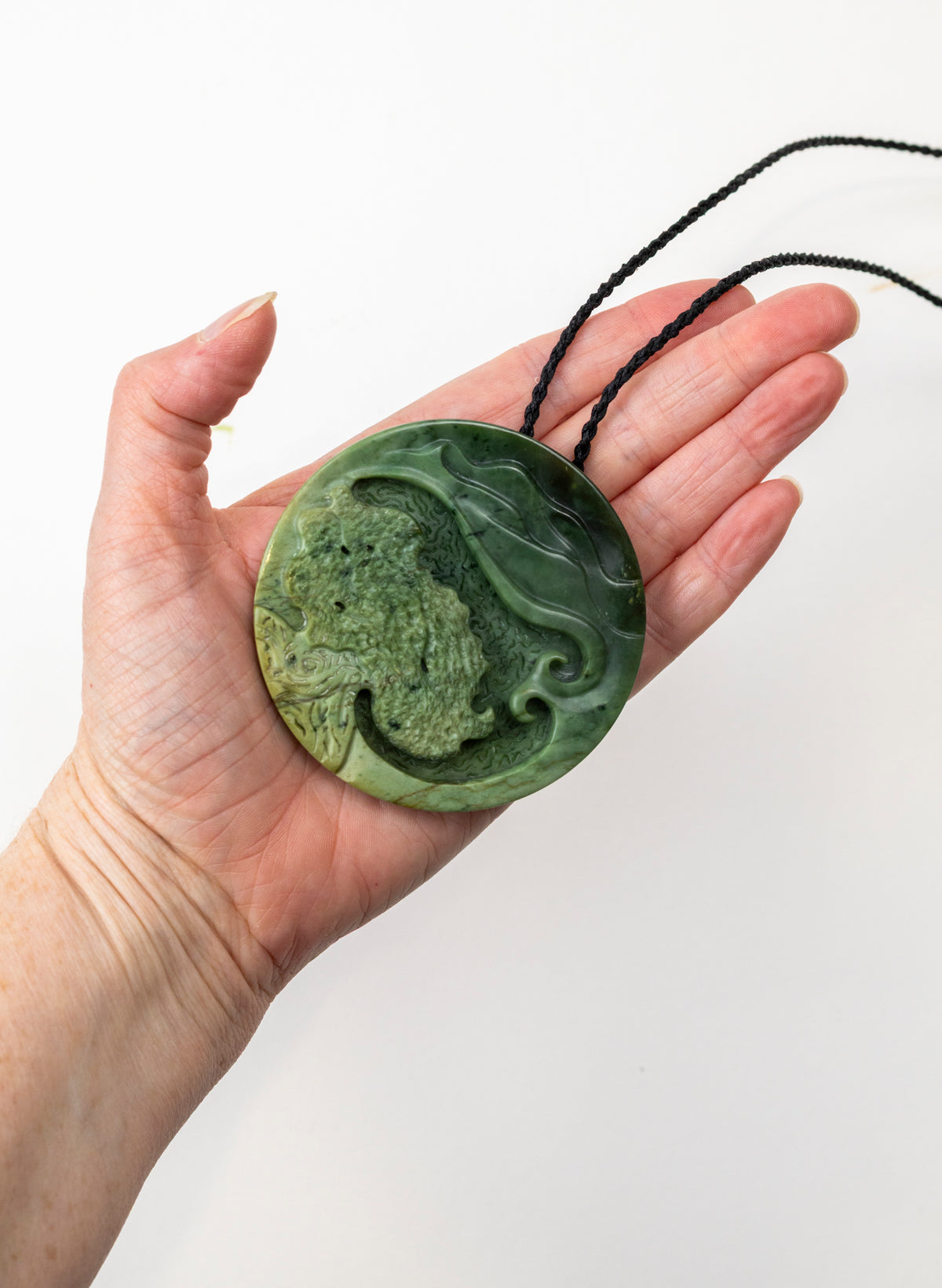 Carved Pounamu Porohita Sculpture on a Stand