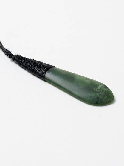 Angled close-up of the Kahurangi pounamu roimata pendant and black binding