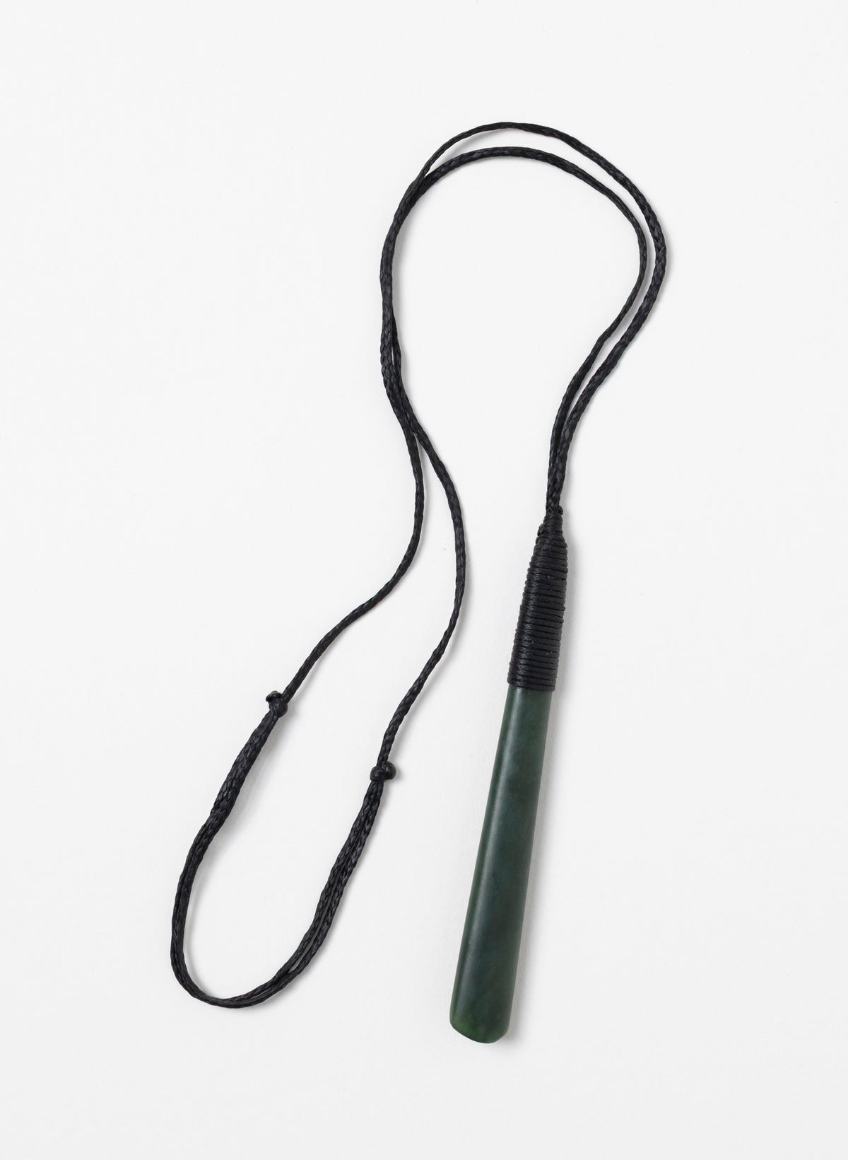 Long narrow Kawakawa pounamu toki pendant with its full black cord