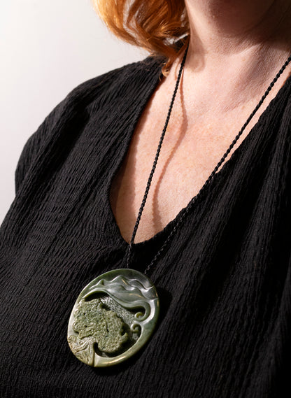 Carved Pounamu Porohita Sculpture on a Stand