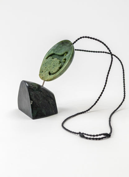 Carved Pounamu Porohita Sculpture on a Stand