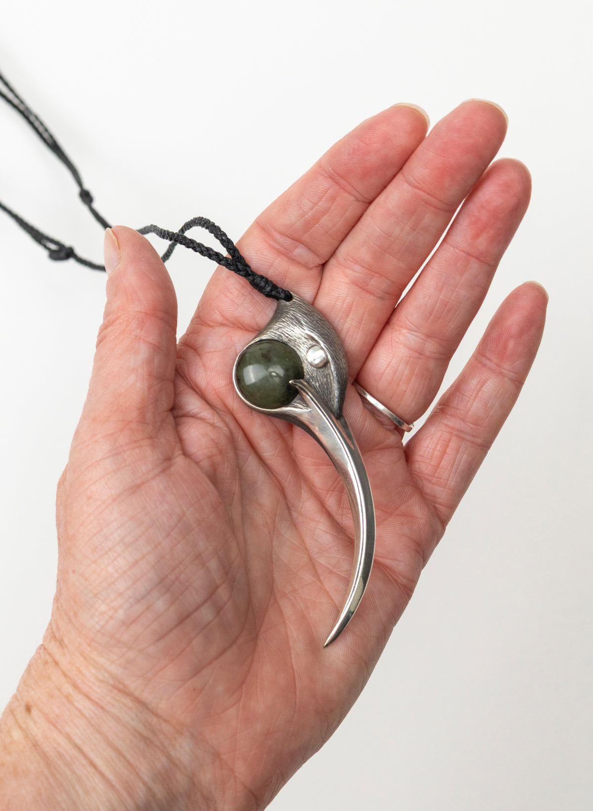 Sterling Silver Female Huia Pendant with a Pounamu Insert