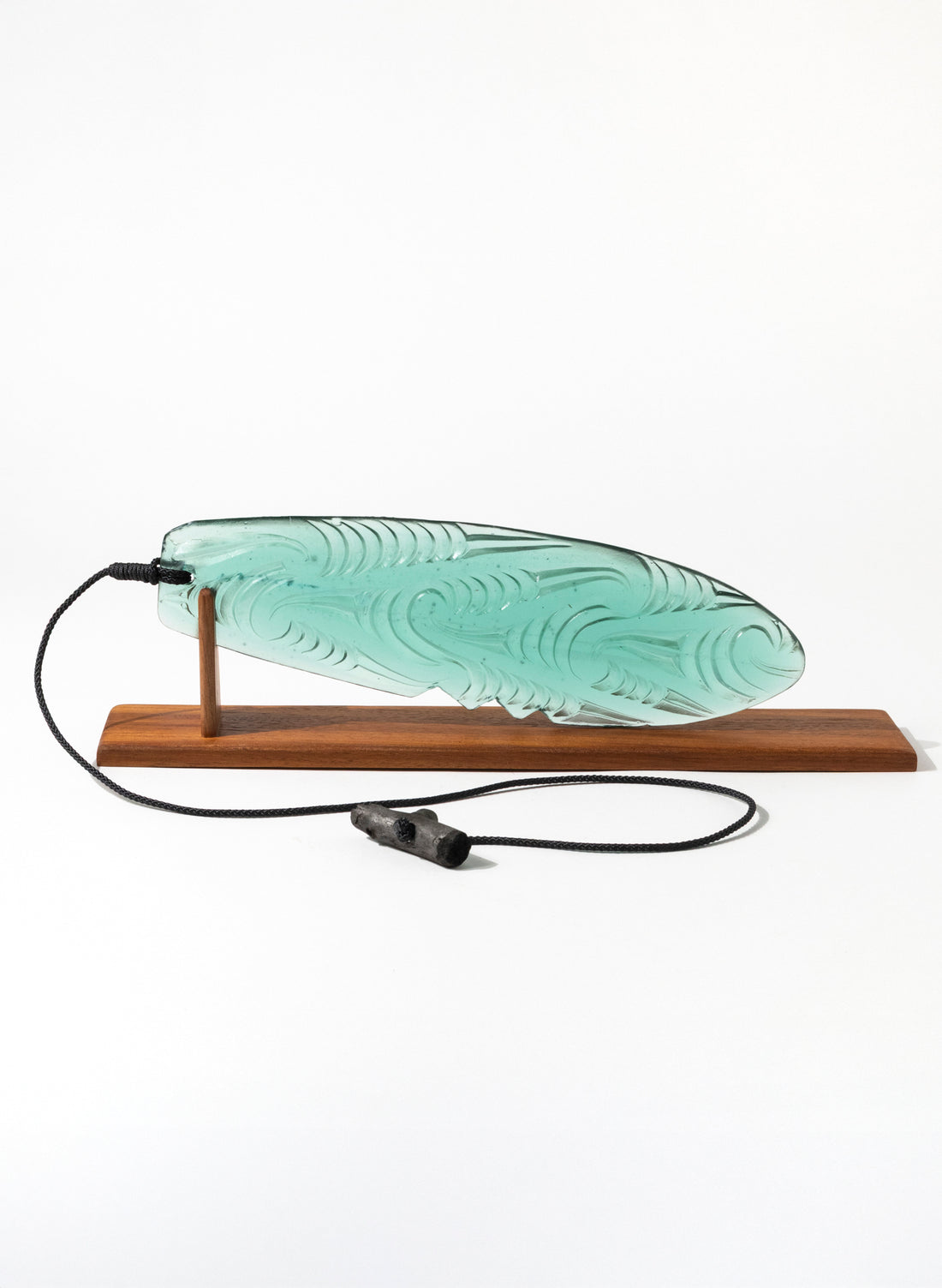 Jade Pūrerehua with Puhoro design, on a rosewood bas