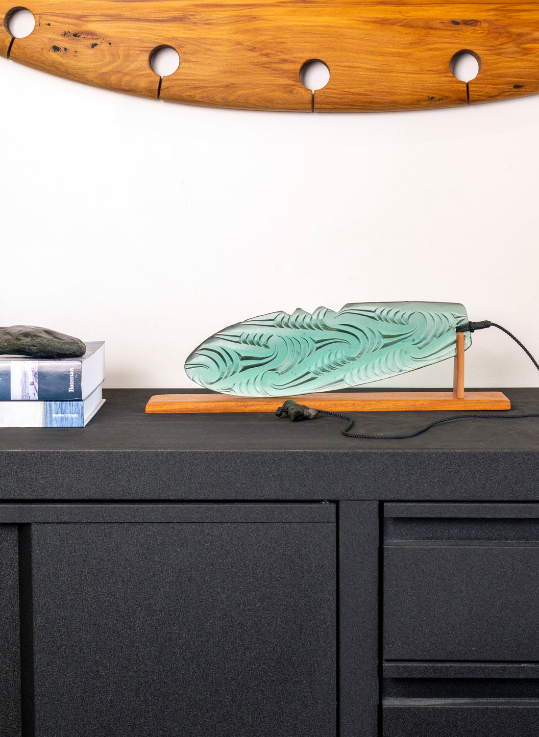 Jade Pūrerehua with Puhoro design, on a rosewood bas