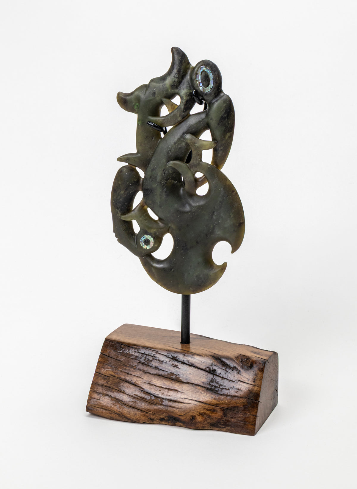 Manaia Pounamu on a Stand, full dark green carving mounted on a black rod and wooden base