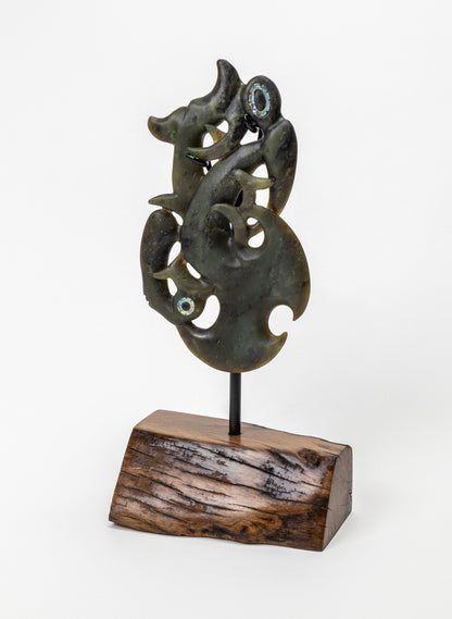 Manaia Pounamu on a Stand, full dark green carving mounted on a black rod and wooden base