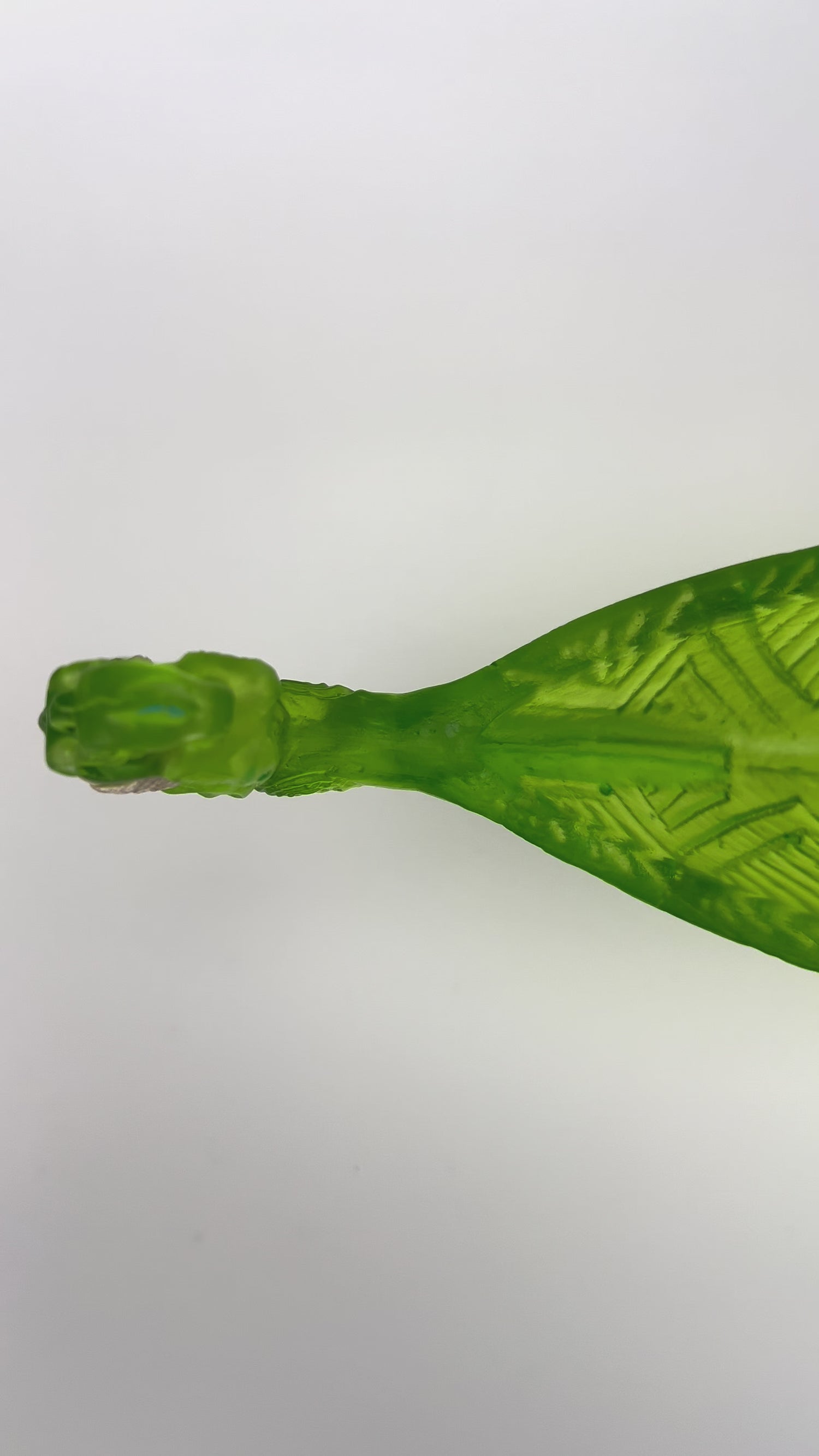 Green Manaia with standing Tangaroas